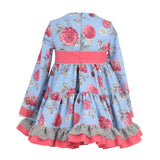 Vestido niña fondo celeste y flor buganvilla  de La Ormiga.