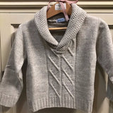 Jersey niño con cuello camionero y trenzas de Nezo.